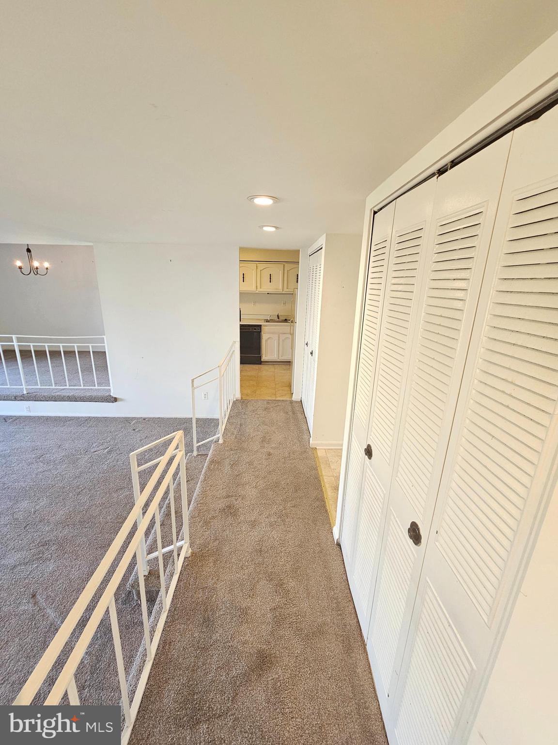 9900 Georgia Avenue, Unit 415 Silver Spring, MD 20902 - Photo 4 of 25 a view of a hallway with staircase