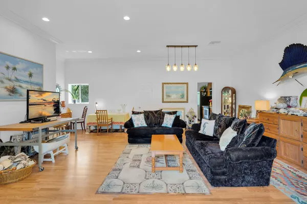 a living room with furniture a rug and a flat screen tv