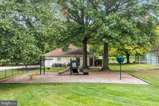 a view of a park with lawn chairs and a slide
