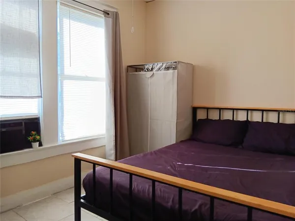 a bedroom with a bed and a window