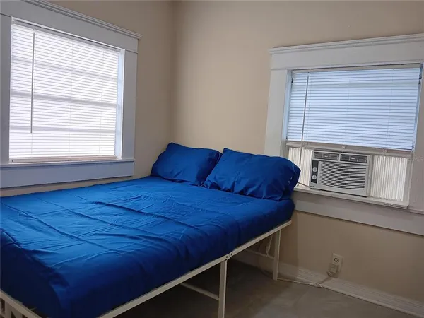 a room with a bed and a window