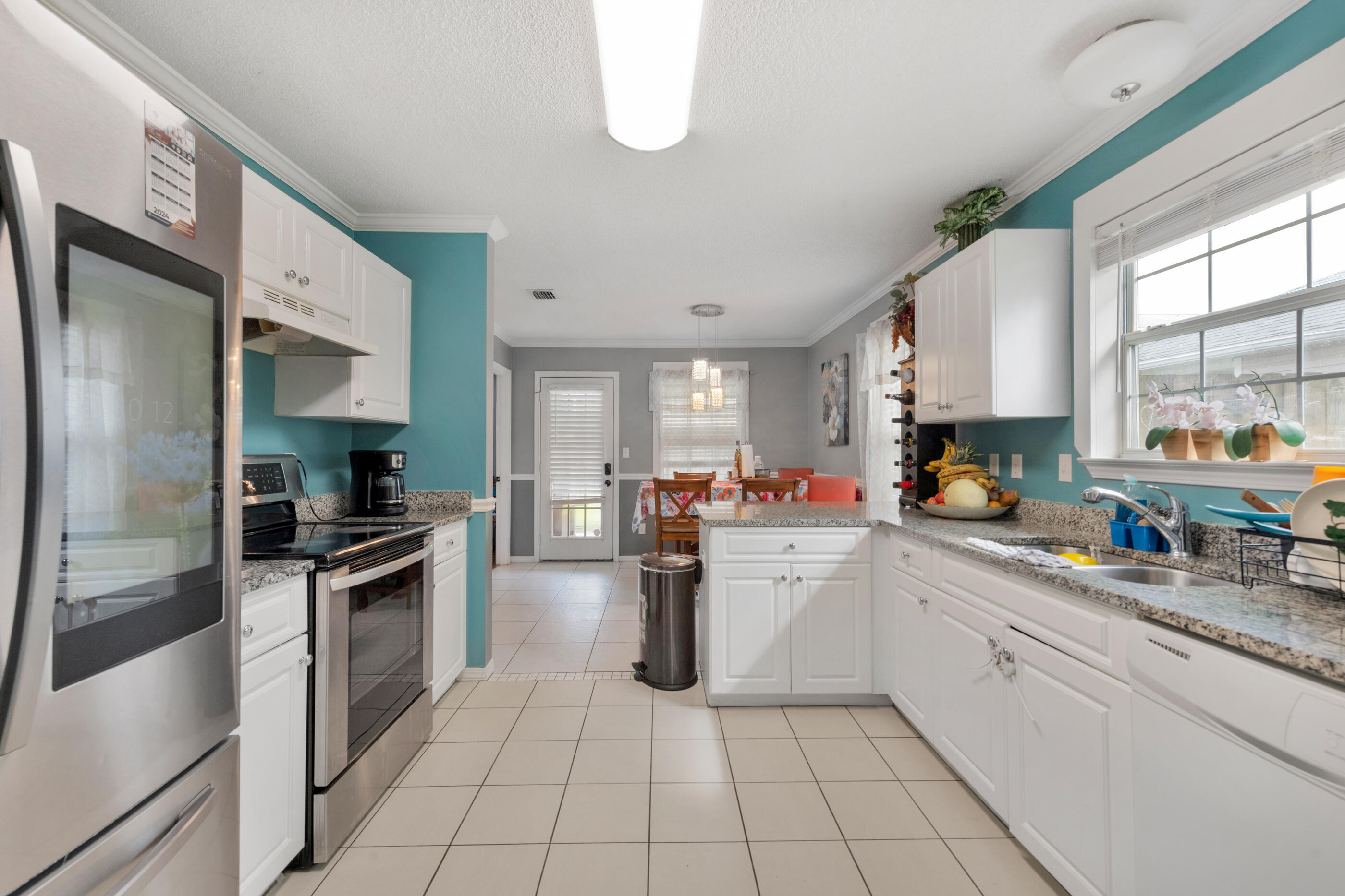 1788 Old Ranch Road Fort Walton Beach, FL 32547 - Photo 8 of 17 a kitchen with stainless steel appliances granite countertop a sink and a refrigerator