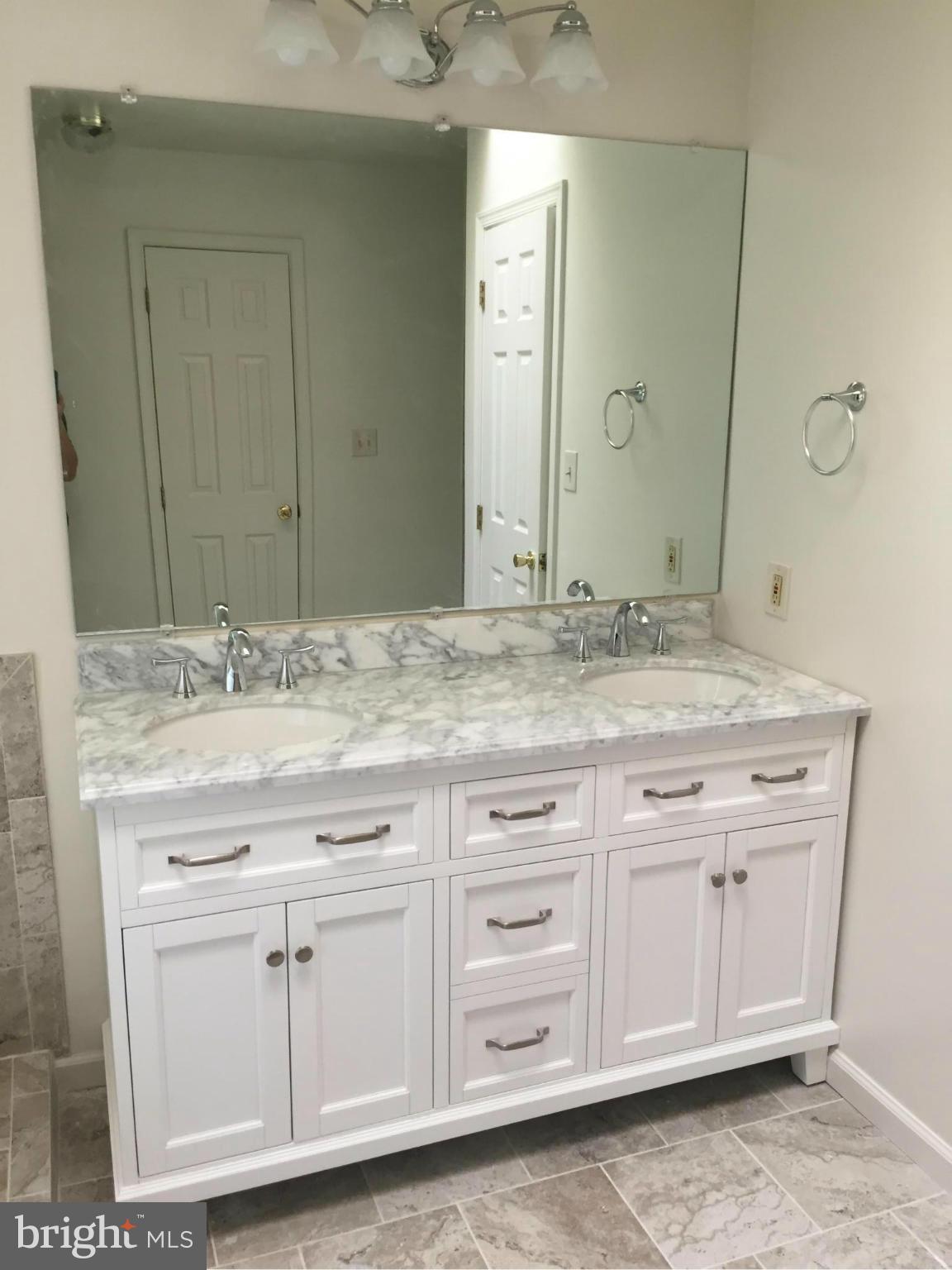 12205 Pleasant Prospect Bowie, MD 20721 - Photo 16 of 30 a bathroom with a sink and a mirror