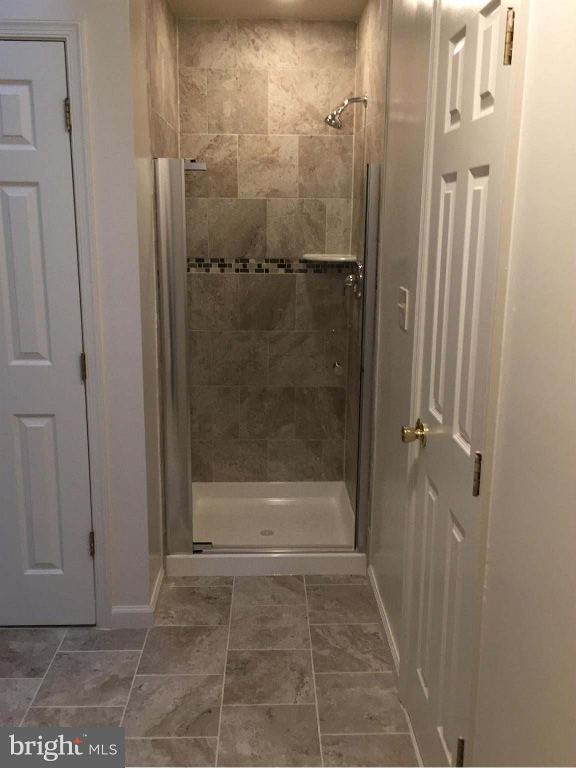 12205 Pleasant Prospect Bowie, MD 20721 - Photo 17 of 30 a bathroom with a glass shower door