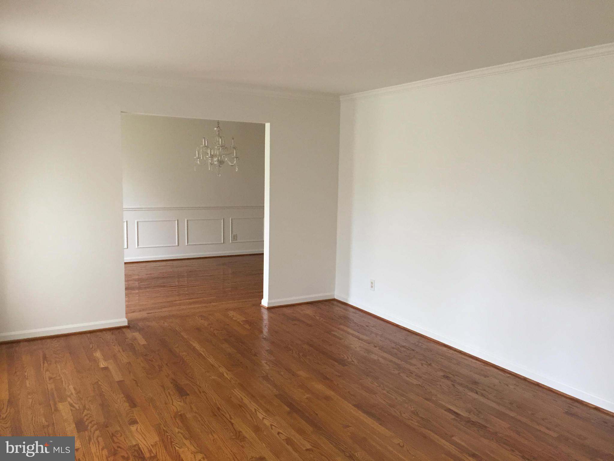 12205 Pleasant Prospect Bowie, MD 20721 - Photo 3 of 30 an empty room with wooden floor and white walls