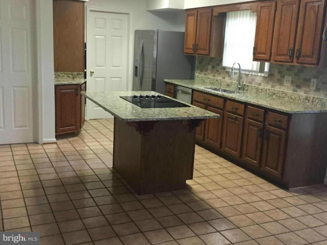 12205 Pleasant Prospect Bowie, MD 20721 - Photo 6 of 30 a kitchen with stainless steel appliances granite countertop a sink stove and refrigerator