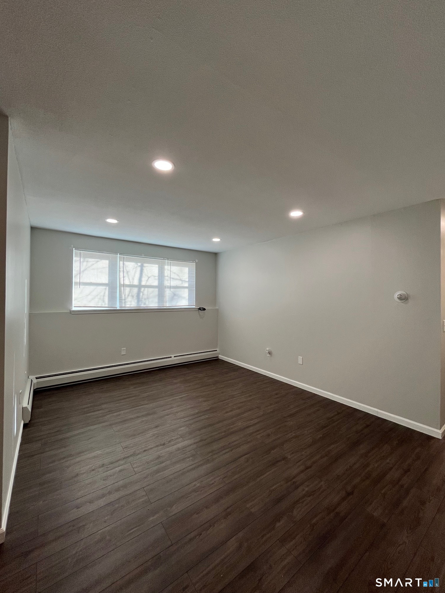 270 High Street, Unit A2 Torrington, CT 06790 - Photo 4 of 5 a view of an empty room with wooden floor and a window