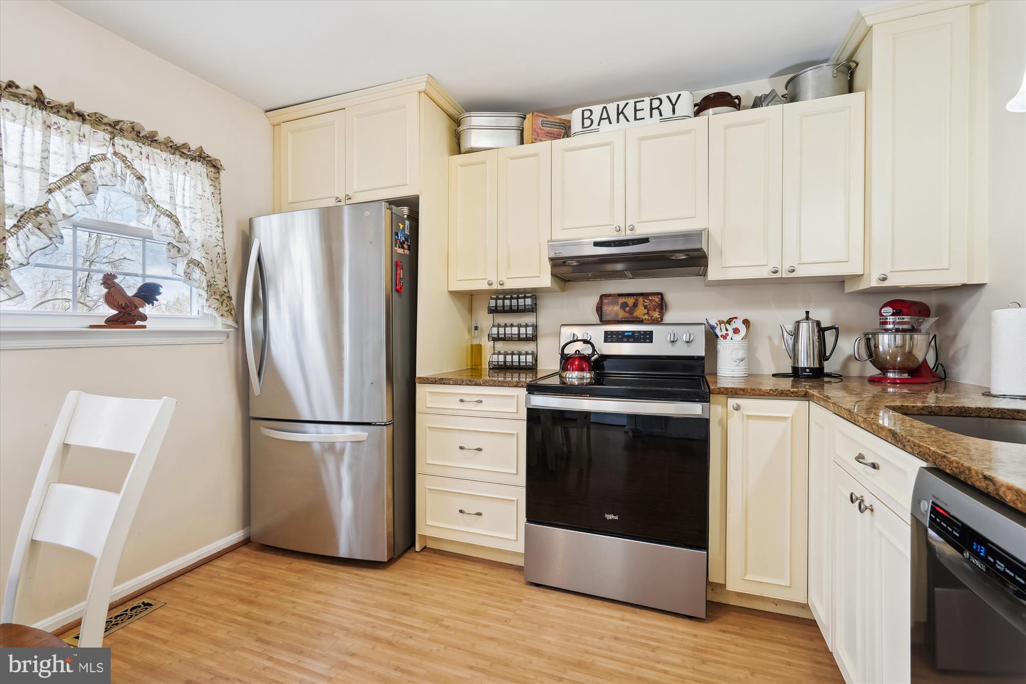 18244 Fox Chase Circle Olney, MD 20832 - Photo 11 of 26 a kitchen with cabinets stainless steel appliances and wooden floor