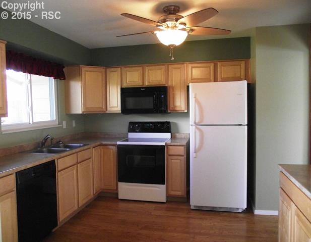 4851 Del Sol Road Colorado Springs, CO 80918 - Photo 1 of 8 Lots of cabinets and counter space for storage and meal prep. Beautiful hard wood floors throughout the kitchen and dining area.