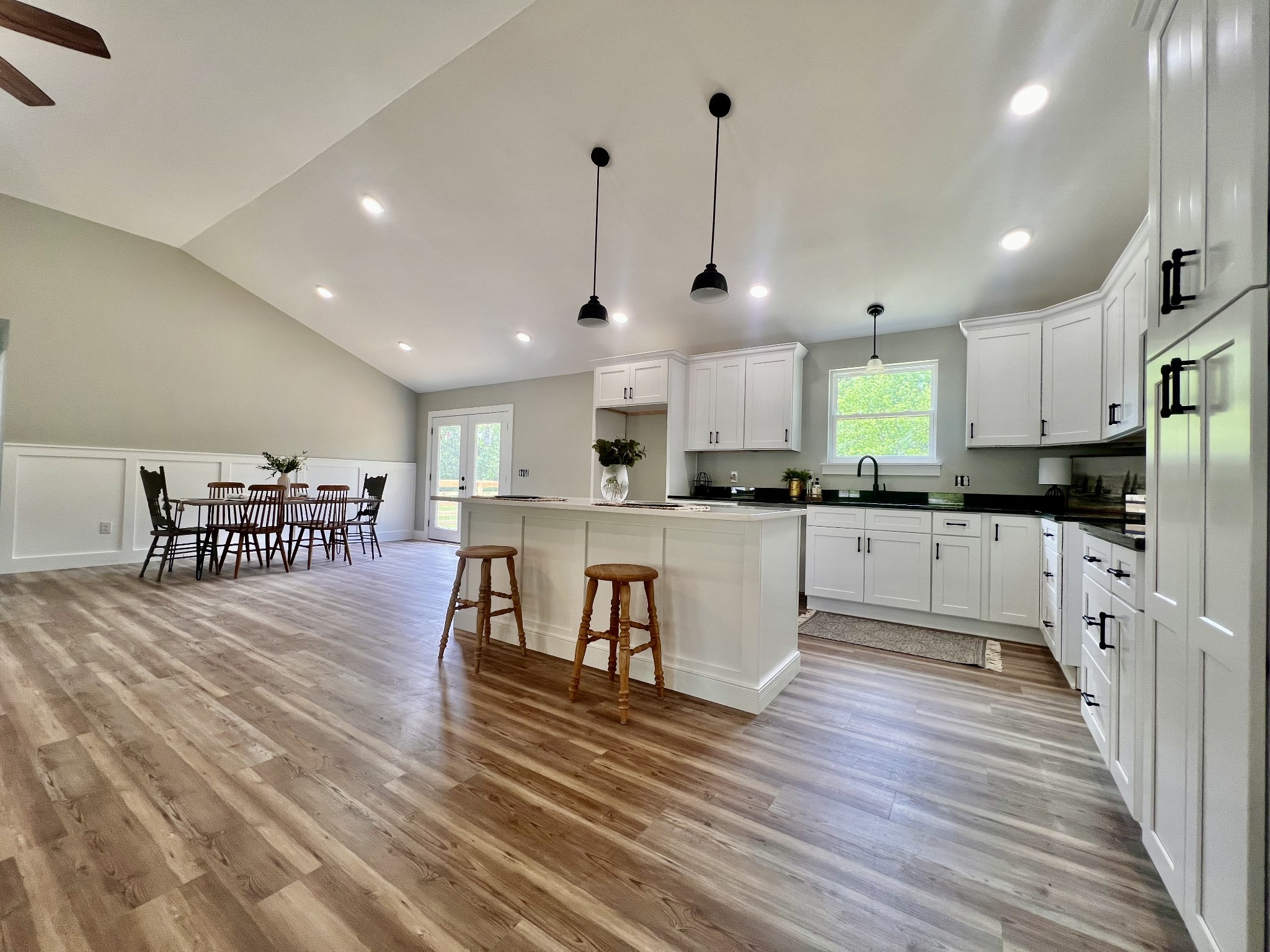 417 Defeated Creek Highway Carthage, TN 37030 - Photo 8 of 30 a large kitchen with stainless steel appliances refrigerator a stove a sink dishwasher with a dining table and chairs with wooden floor