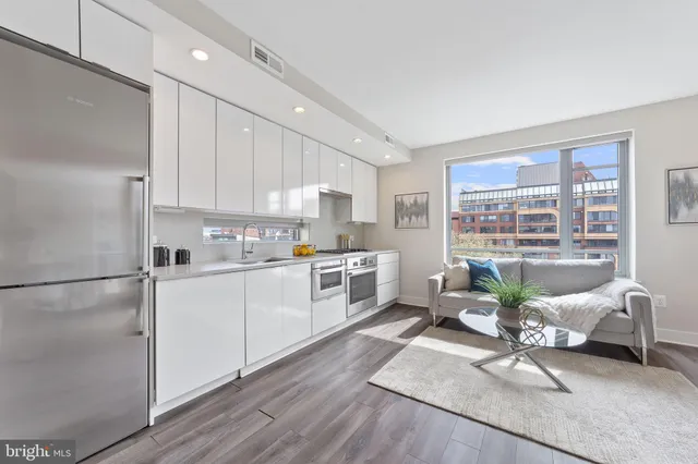 a kitchen with white cabinets and white appliances
