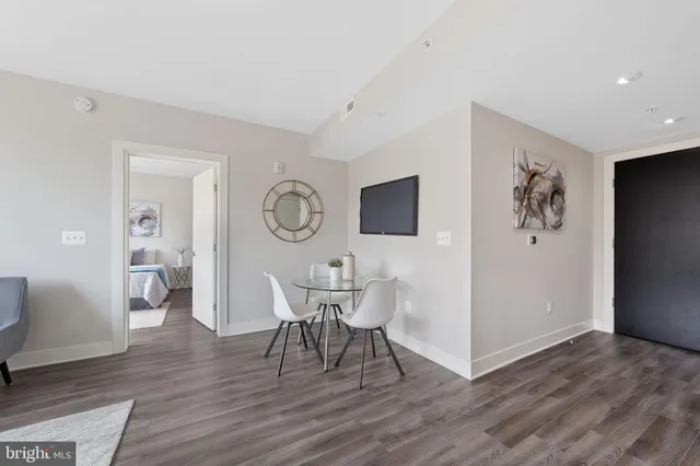 a view of a dining room with furniture and wooden floor