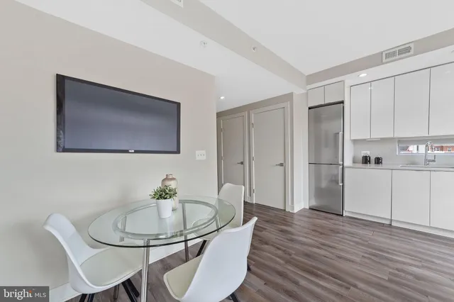 a view of a dining room with furniture and wooden floor