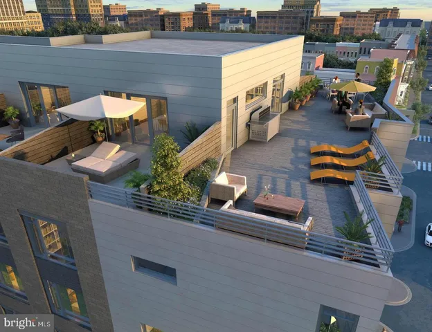 an aerial view of a house with garden space and sitting area