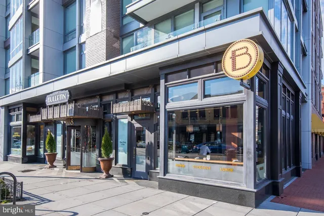 a view of a brick building with a clock on the wall