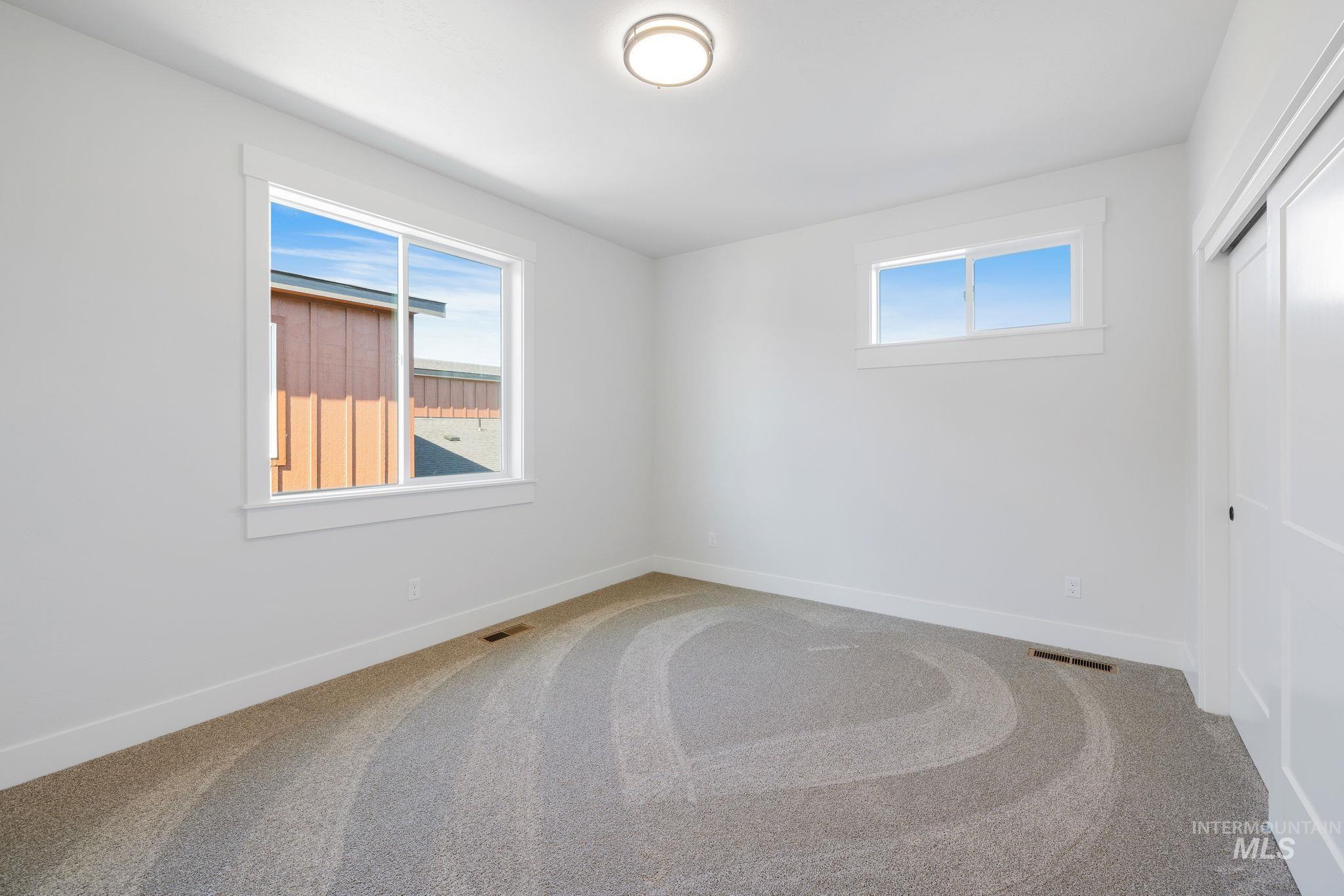 18 Ogden Street Cascade, ID 83611 - Photo 27 of 39 Carpeted spare room with healthy amount of natural light