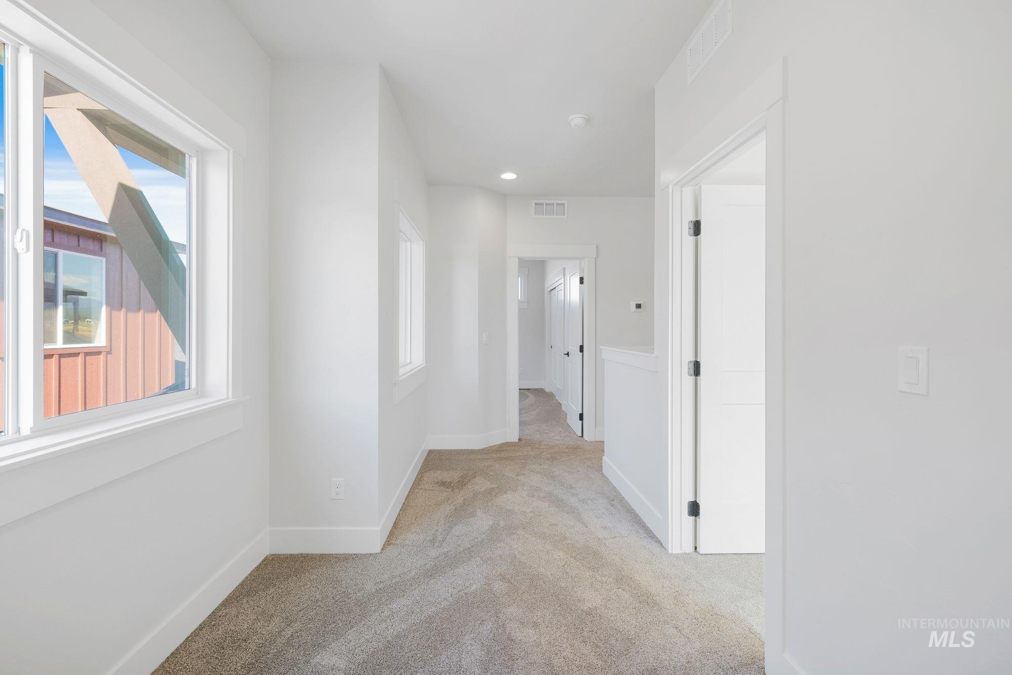 18 Ogden Street Cascade, ID 83611 - Photo 33 of 39 Corridor featuring light colored carpet and baseboards