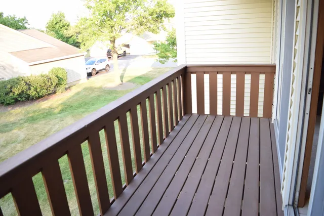 a view of balcony with wooden floor