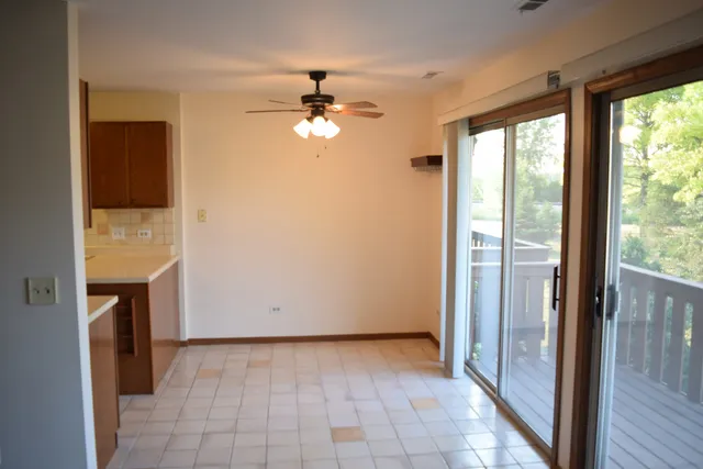 a view of an empty room with a fireplace and a window