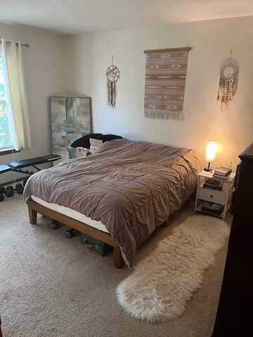 a bedroom with a bed and window