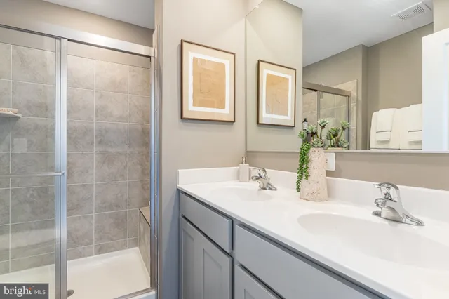 a view of a workspace room with wooden floor and furniture