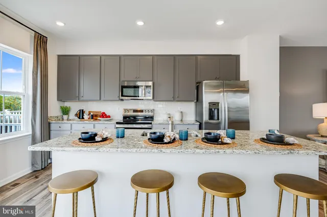 a kitchen with a table chairs stove and refrigerator