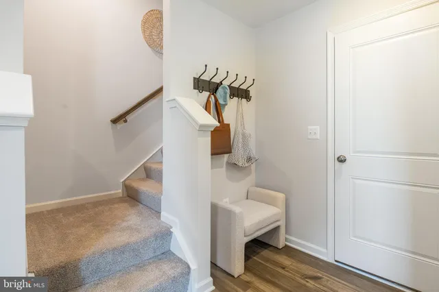 a view of entryway and hall with wooden floor