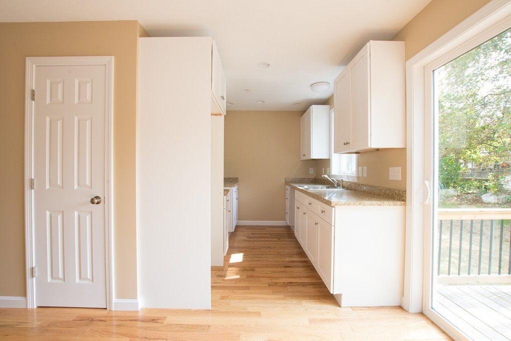 17 Arcade Street, Unit B Northbridge, MA 01588 - Photo 13 of 29 a large white kitchen with granite countertop a sink