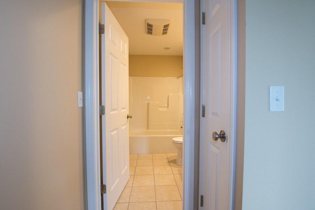 17 Arcade Street, Unit B Northbridge, MA 01588 - Photo 14 of 29 a bathroom with a glass shower door and a sink