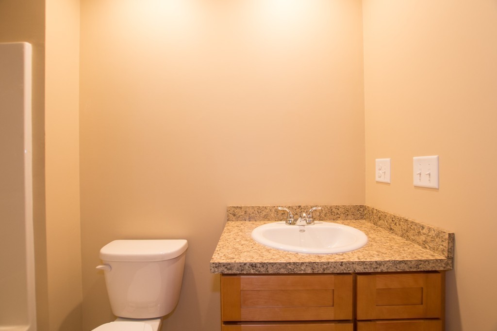 17 Arcade Street, Unit B Northbridge, MA 01588 - Photo 16 of 29 a bathroom with a granite countertop sink and a mirror