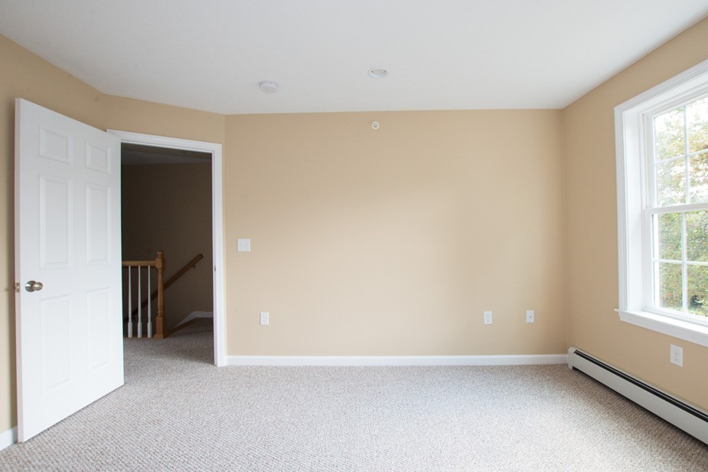 17 Arcade Street, Unit B Northbridge, MA 01588 - Photo 19 of 29 an empty room with windows and closet