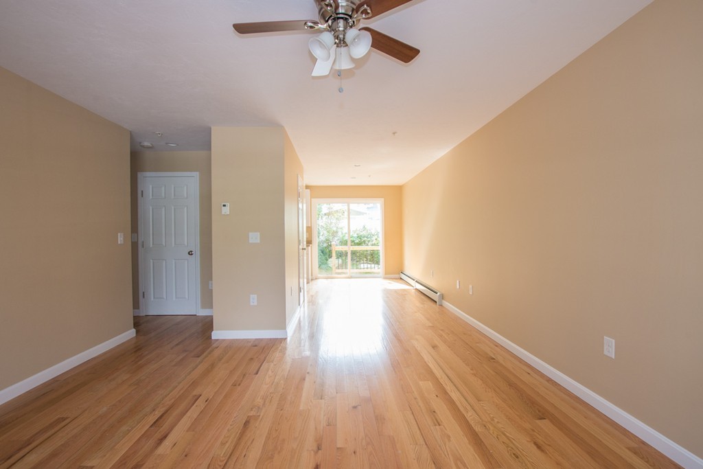 17 Arcade Street, Unit B Northbridge, MA 01588 - Photo 4 of 29 a view of an empty room with wooden floor and a window