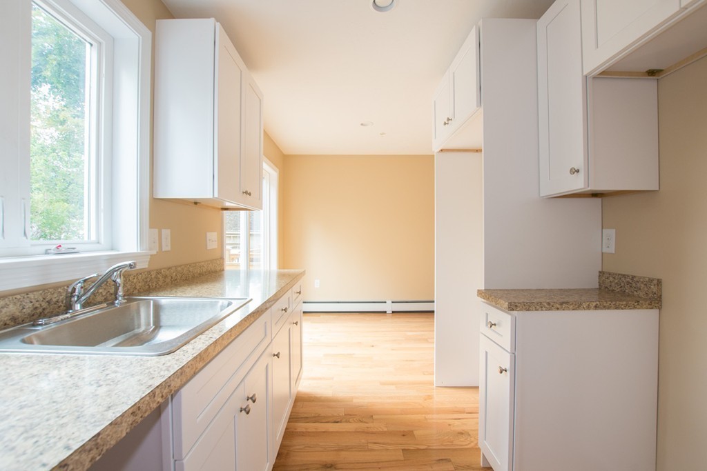17 Arcade Street, Unit B Northbridge, MA 01588 - Photo 9 of 29 a kitchen with granite countertop a sink a counter top space and cabinets