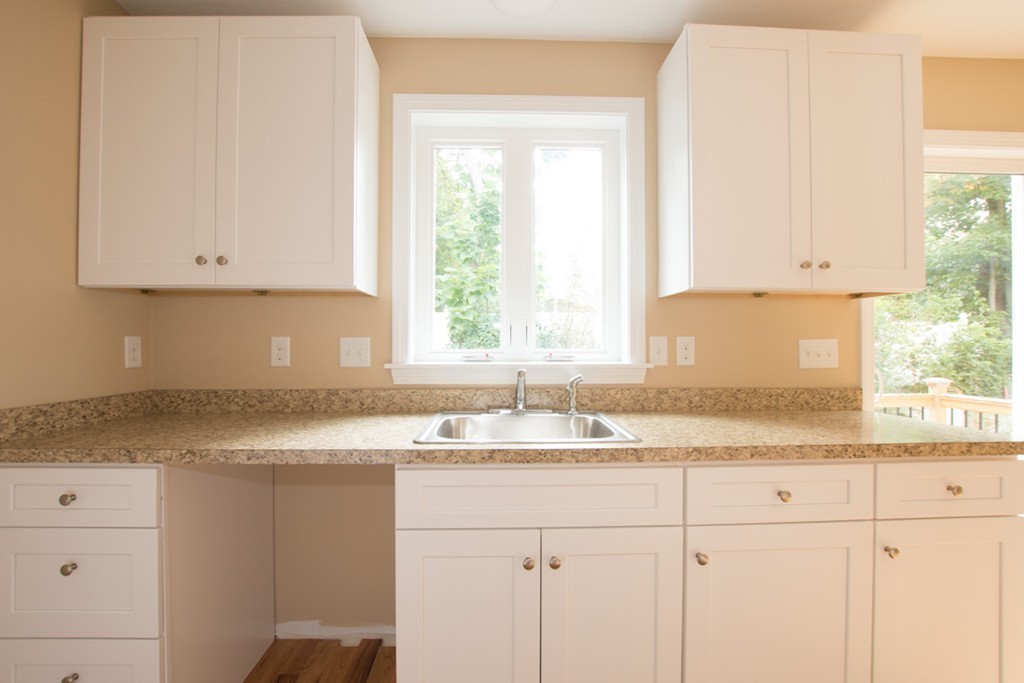 17 Arcade Street, Unit B Northbridge, MA 01588 - Photo 10 of 29 a kitchen with granite countertop white cabinets and a window