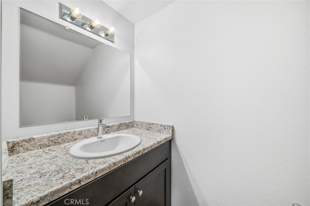 529 South Pine Street Santa Maria, CA 93458 - Photo 13 of 53 a bathroom with a granite countertop sink and a mirror