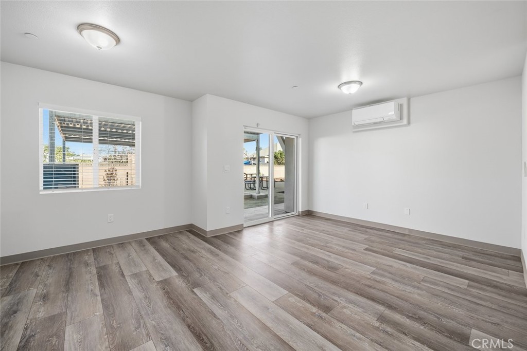 529 South Pine Street Santa Maria, CA 93458 - Photo 30 of 53 an empty room with wooden floor and windows