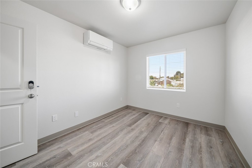 529 South Pine Street Santa Maria, CA 93458 - Photo 33 of 53 an empty room with wooden floor and windows