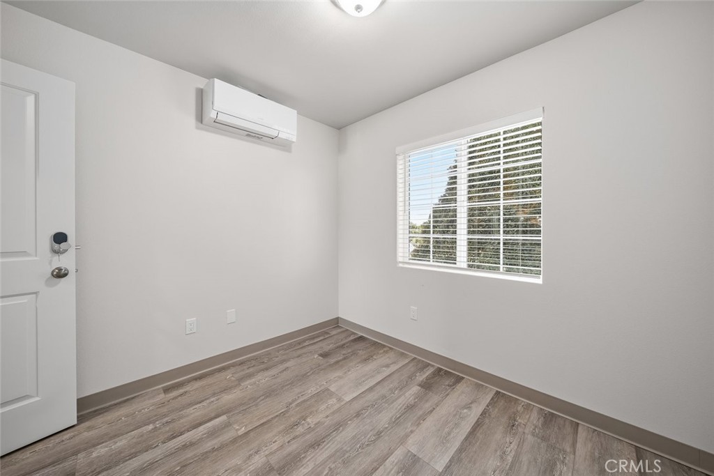 529 South Pine Street Santa Maria, CA 93458 - Photo 38 of 53 an empty room with wooden floor and windows
