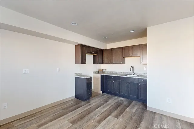a kitchen with granite countertop a sink and cabinets