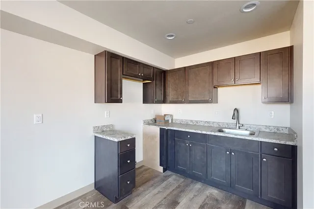 a kitchen with a sink a stove and cabinets