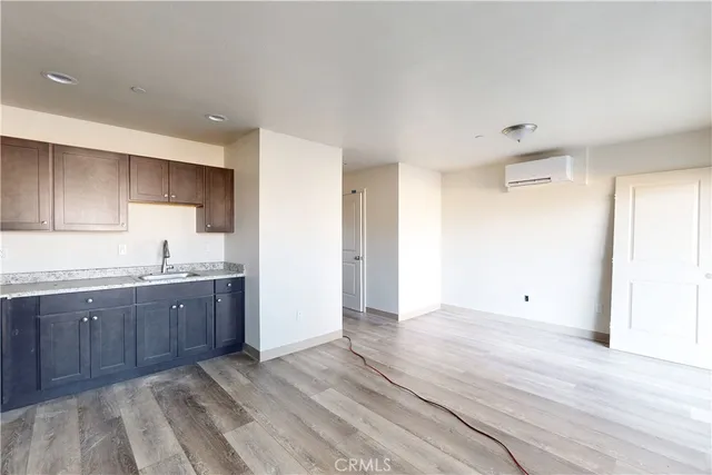 a view of kitchen with granite countertop cabinets and sink