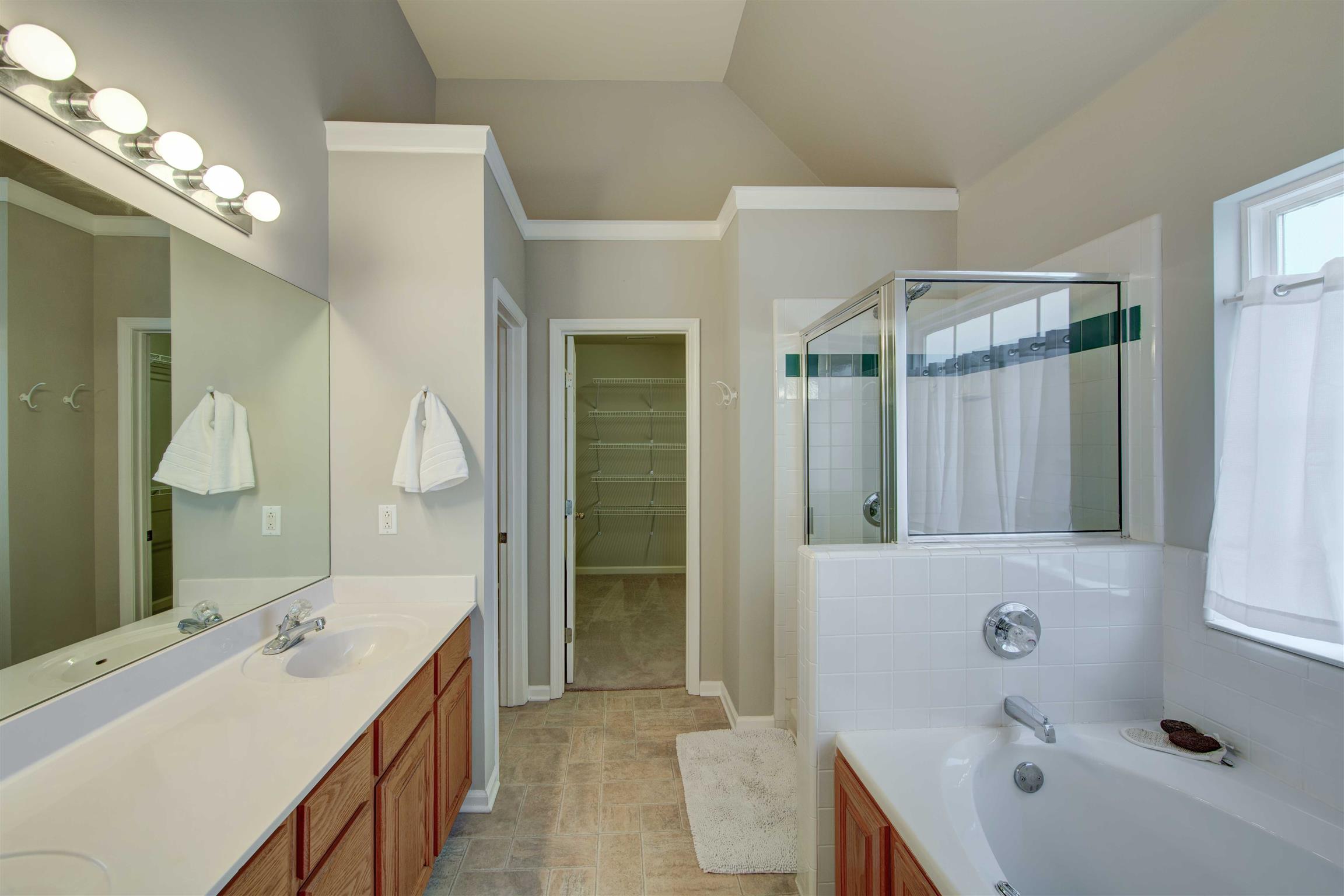 1801 O'Reilly Circle Spring Hill, TN 37174 - Photo 20 of 22 Enjoy a spa like experience in your jetted tub. Walk in tiled shower walls add an elegant touch.