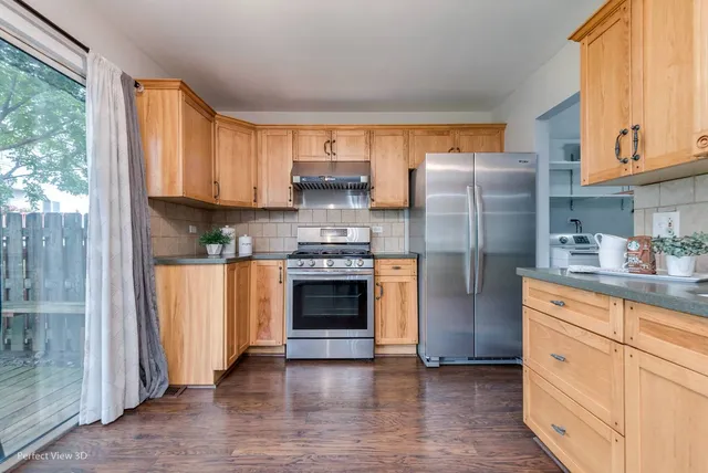 a kitchen with stainless steel appliances a refrigerator sink and cabinets