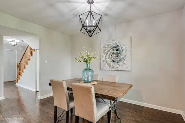 a view of a dining room with furniture wooden floor and a chandelier