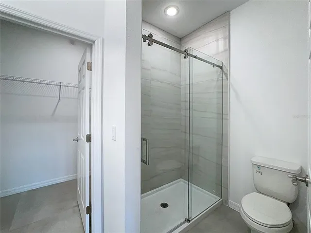 an empty room with a bathroom space and sink