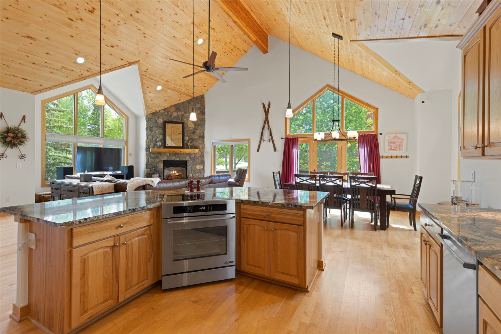 736 Wild Rose Road Silverthorne, CO 80498 - Photo 14 of 49 Kitchen with stainless steel dishwasher, oven, high vaulted ceiling, a fireplace, and a wooden ceiling with exposed beams