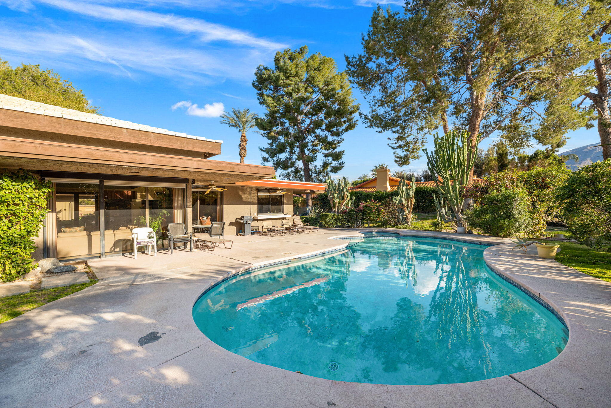 40675 East Thunderbird Terrace Rancho Mirage, CA 92270 - Photo 16 of 58 a view of a swimming pool with an outdoor seating