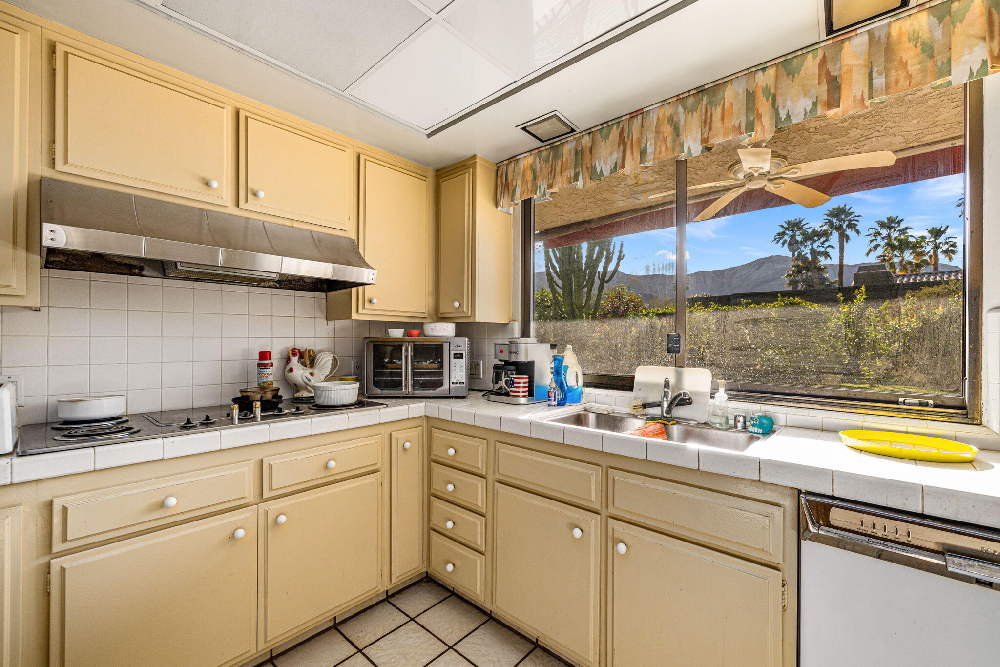 40675 East Thunderbird Terrace Rancho Mirage, CA 92270 - Photo 38 of 58 a kitchen with stainless steel appliances granite countertop a sink a stove and cabinets
