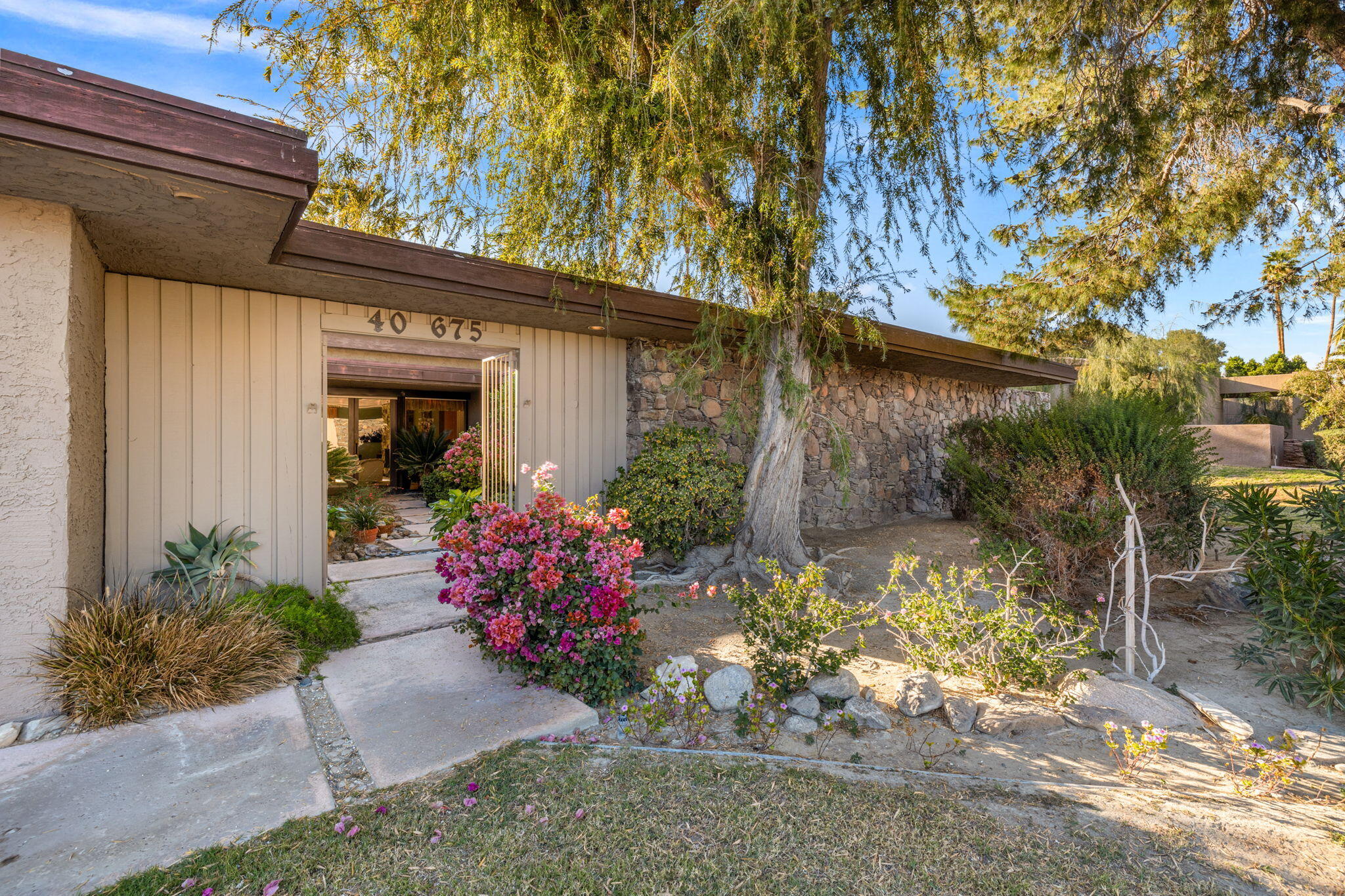 40675 East Thunderbird Terrace Rancho Mirage, CA 92270 - Photo 5 of 58 a front view of a house with a yard