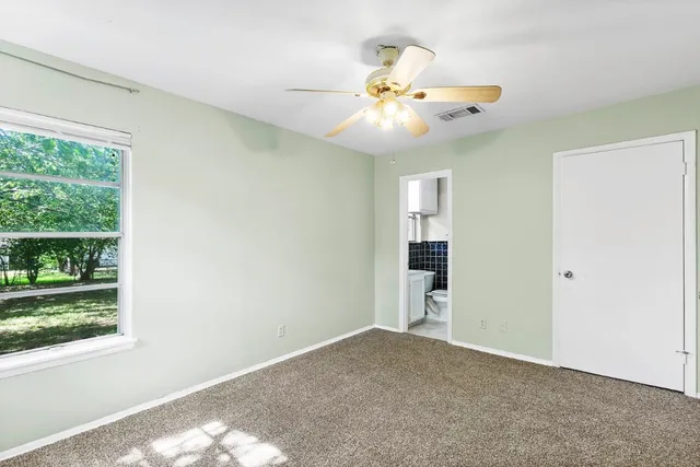 a view of an empty room with a window